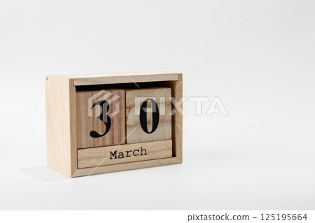 Wooden calendar March 30 on a white background Wooden calendar March 30 on a white background 125195664