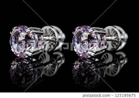 earrings silver, gold with stone morganite, diamonds on black background earrings silver, gold with stone morganite, diamonds on black background 125195675