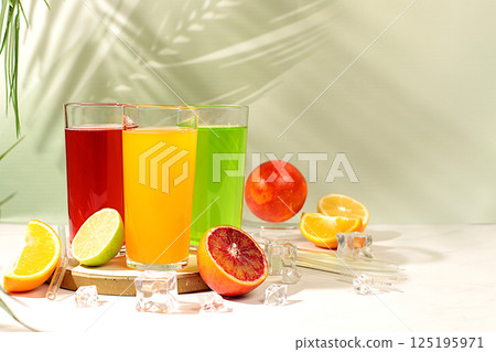 Assortment of summer dietary citrus drinks. Cocktails and juices from orange, lime and grapefruit. Concept of tropical party and relaxation, advertising of healthy lifestyle. 125195971