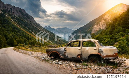 Abandoned and decaying car on the side of the road 125197634