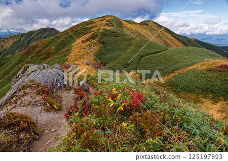View of autumn foliage of Mt. Tainai from Monnai hut in the Iide mountain range View of autumn foliage of Mt. Tainai from Monnai hut in the Iide mountain range 125197893