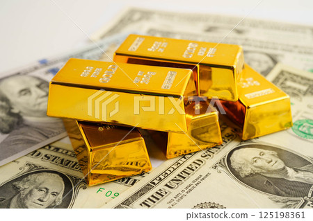 Gold bars on US dollar banknote money, finance trading investment business currency concept. 125198361