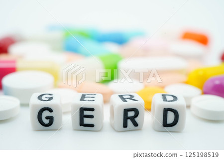 GERD Gastro esophageal Reflux Disease word with pills and capsules medical drug. 125198519