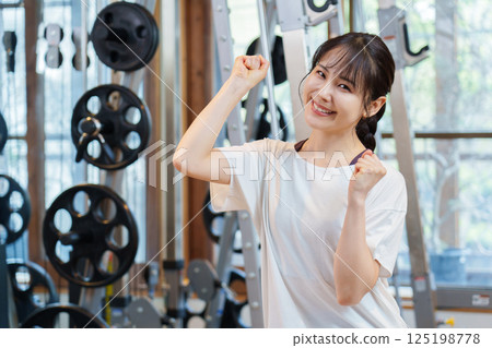 A woman doing a fist pump at the gym A woman doing a fist pump at the gym 125198778