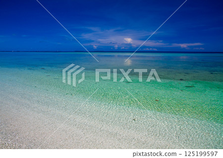 The vivid blue lagoon of Fongafale Island in Funafuti Atoll, the capital of Tuvalu, an island nation in Oceania and Polynesia The vivid blue lagoon of Fongafale Island in Funafuti Atoll, the capital of Tuvalu, an island nation in Oceania and Polynesia 125199597