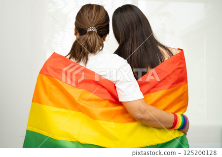 Asian couple woman with LGBT rainbow flag. Asian couple woman with LGBT rainbow flag. 125200128