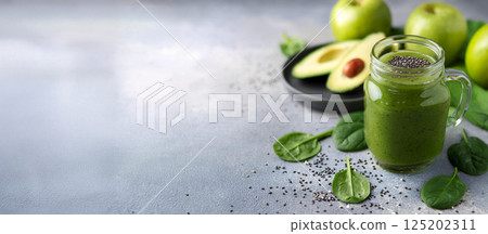 A healthy vegetarian green smoothie with avocado, spinach, apple and chia seeds. 125202311