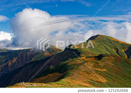 Mount Kitamata and the flowing clouds seen from Mount Monnai in the Iide mountain range 125202698