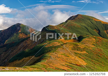 Mount Kitamata and Mount Baikabi seen from Mount Monnai in the Iide mountain range, with the clouds drifting by Mount Kitamata and Mount Baikabi seen from Mount Monnai in the Iide mountain range, with the clouds drifting by 125202708