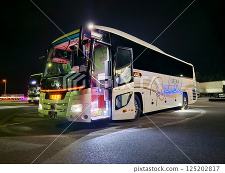 Bus running late at night 125202817