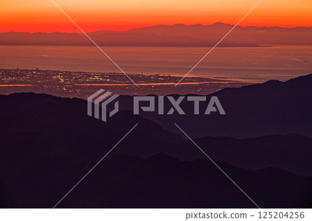 The Sea of Japan and the Sado mountain range in the afterglow as seen from Mount Onishi in the Iide mountain range The Sea of Japan and the Sado mountain range in the afterglow as seen from Mount Onishi in the Iide mountain range 125204256