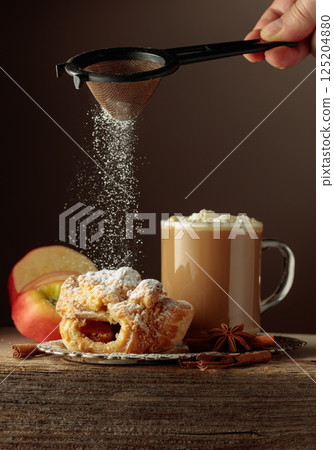 Vienna strudel and caffe latte on an old wooden table. Vienna strudel and caffe latte on an old wooden table. 125204880