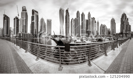 Panoramic view of Dubai Marina bay with yacht and cloudy sky, Dubai, UAE. Panoramic view of Dubai Marina bay with yacht and cloudy sky, Dubai, UAE. 125204990