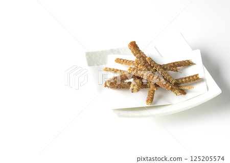 Eel bone rice crackers photographed against a white background 125205574