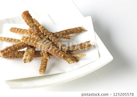 Eel bone rice crackers photographed against a white background 125205578