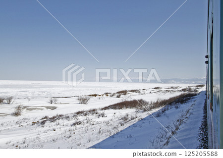 View of drift ice in the Sea of Okhotsk from the window of the Senmo Main Line train. Drift Ice Story Train and Drift Ice Norokko Train 125205588