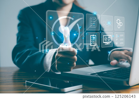 Service guarantee, validation certificate concept for business process automation, quality assurance management, approved, digital evaluation. Business woman touching checked icon on virtual screen. Service guarantee, validation certificate concept for business process automation, quality assurance management, approved, digital evaluation. Business woman touching checked icon on virtual screen. 125206143