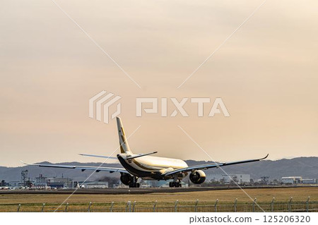 Sendai Airport at dusk, airplane taking off, Natori City, Miyagi Prefecture 125206320