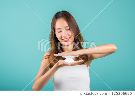 Portrait Asian young woman hands are adorned with white foam mousse studio shot isolated on blue background, beautiful female holds a cleansing foam near her face, Cosmetics beauty skincare Portrait Asian young woman hands are adorned with white foam mousse studio shot isolated on blue background, beautiful female holds a cleansing foam near her face, Cosmetics beauty skincare 125206690