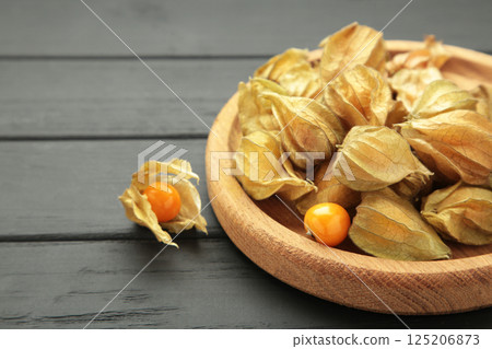 Physalis peruviana fruit on black wooden background. 125206873