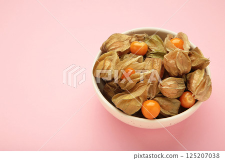 Physalis peruviana fruit on light plate on pink background. 125207038