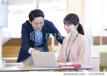 Business: Men and women having a meeting Photo courtesy of: Denpa Gakuen, Tokyo Electronics College 125207099