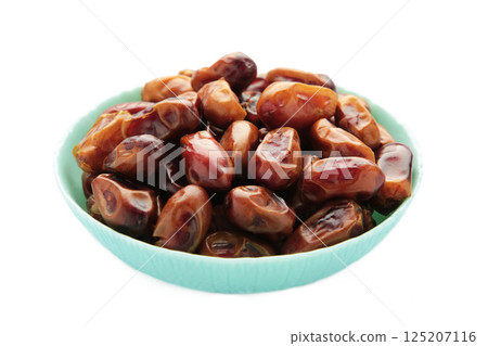 Fresh dates in mint bowl isolated on white background. Close up 125207116