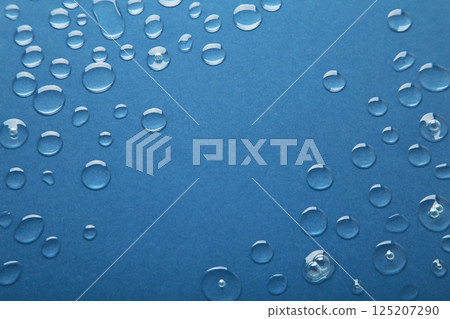 Water drops on dark blue background. Space for text 125207290