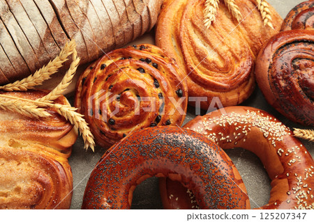 Bakery - various kinds of breadstuff. Bread rolls, bagel, sweet bun. 125207347
