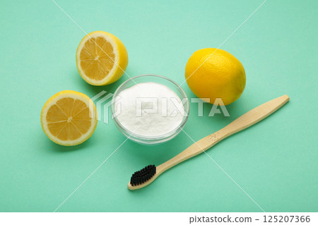 Wooden bamboo eco friendly toothbrushes, baking soda on mint background. Dental care and zero waste concept Wooden bamboo eco friendly toothbrushes, baking soda on mint background. Dental care and zero waste concept 125207366