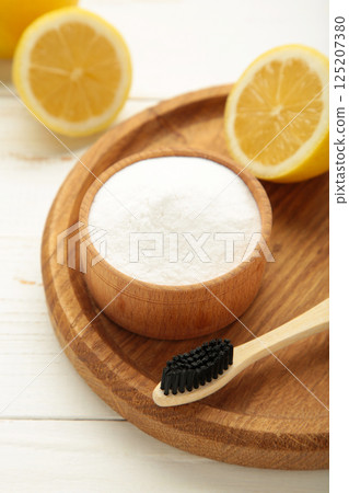 Toothbrush with lemon and baking soda on white background. Vertical photo 125207380