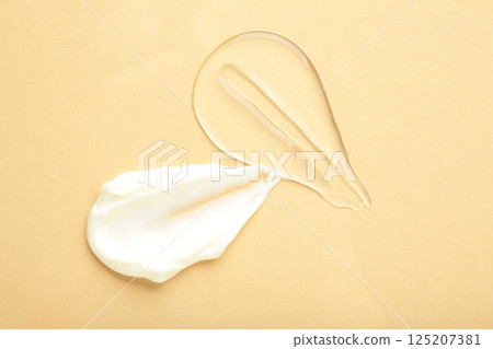 Cosmetic smears of creamy texture on a pastel beige background Cosmetic smears of creamy texture on a pastel beige background 125207381