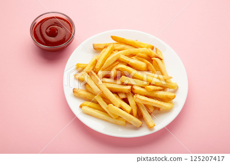 French fries with ketchup in bowl on pink background French fries with ketchup in bowl on pink background 125207417