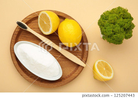 Toothbrush with lemon and baking soda on beige background. 125207443