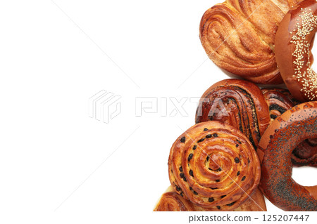 Bakery - various kinds of breadstuff. Bread rolls, bagel, sweet bun isolated on white background. Space for text 125207447