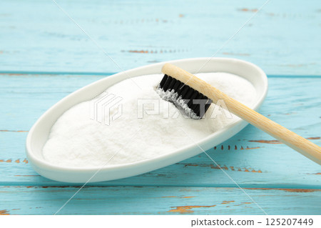 Toothbrush and baking soda to clean on blue background. 125207449