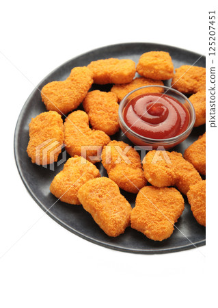 Chicken nuggets with ketchup on plate isolated on white background. 125207451