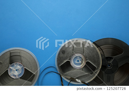 Film reel on blue background. Space for text 125207726