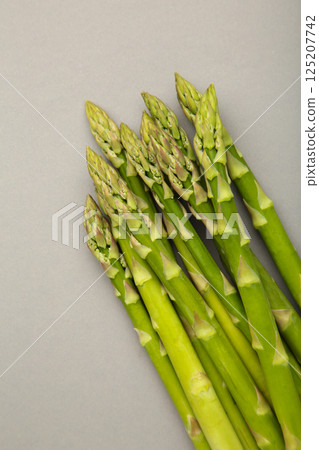 Fresh green asparagus on grey background. Healthy food concept. Vegan healthy food. 125207742