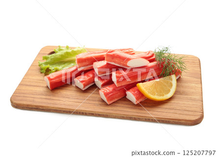 Fresh crab sticks with lemon on cutting board isolated on white background. 125207797