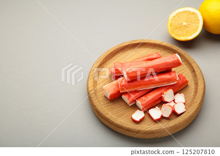 Cut crab sticks in bowl on grey background. Space for text Cut crab sticks in bowl on grey background. Space for text 125207810