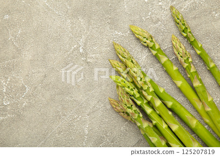 Fresh green asparagus on grey background. Healthy food concept. Vegan healthy food. 125207819