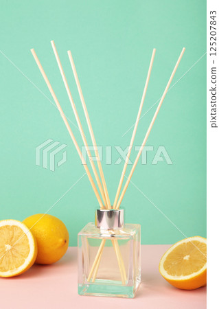 Reed diffuser and lemons on mint background 125207843