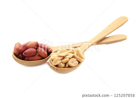Peanuts in spoon isolated on white background. 125207858
