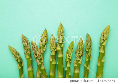 Fresh green asparagus on mint background. Healthy food concept. Vegan healthy food. Top view 125207875