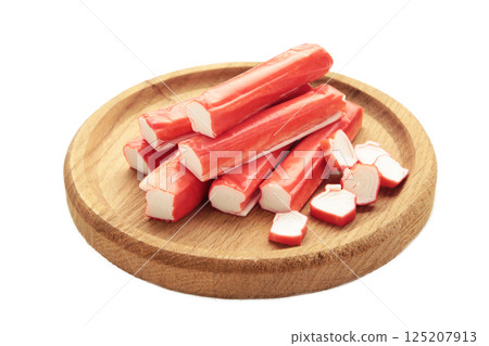 Crab sticks on cutting board isolated on white background. 125207913