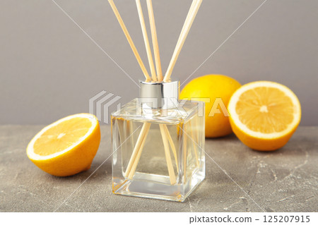Reed diffuser and lemons on grey concrete background Reed diffuser and lemons on grey concrete background 125207915