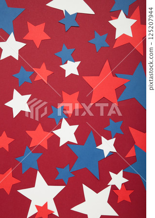 American independence day, celebration, patriotism and holidays concept - red, white and blue paper stars on red background. American independence day, celebration, patriotism and holidays concept - red, white and blue paper stars on red background. 125207944