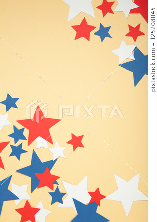 American independence day, celebration, patriotism and holidays concept - red, white and blue paper stars on beige background. American independence day, celebration, patriotism and holidays concept - red, white and blue paper stars on beige background. 125208045