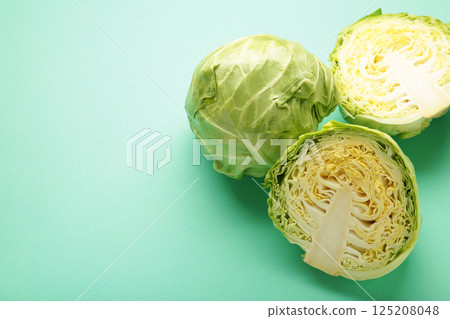 Green cabbage on a mint background. Space for text 125208048